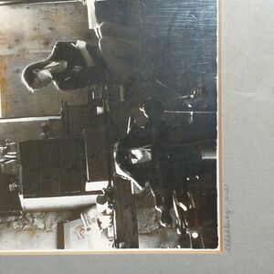 Art Noir Framed Black and White Photo of a Young Woman in a Workshop